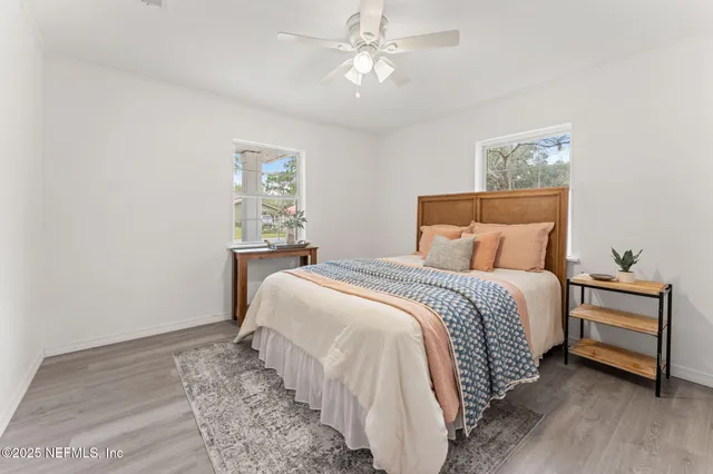 a bedroom with a bed and a painting on the wall