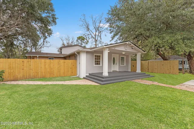 a front view of a house with yard and green space