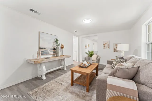 a living room with furniture a rug and a window