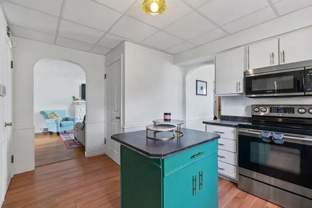 a kitchen with a sink stove and microwave
