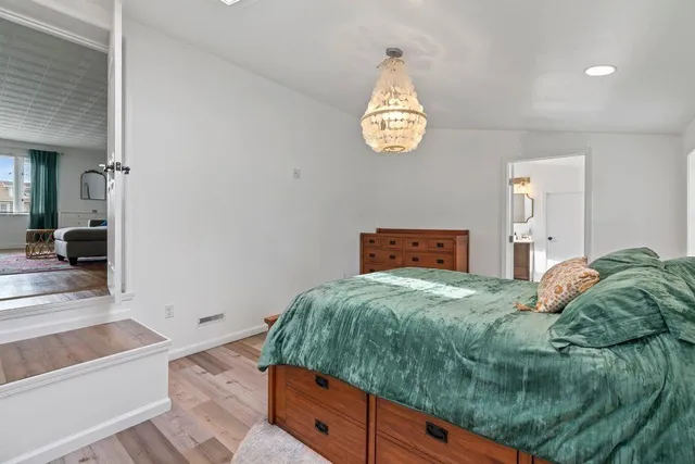 a living room with hard wood flooring and a couch