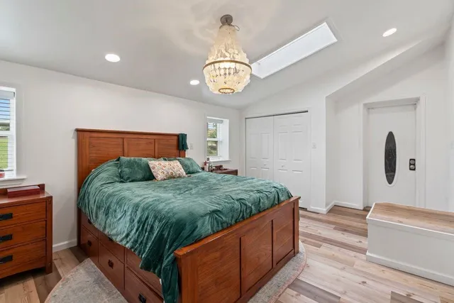 a bed room with a bed and a chandelier