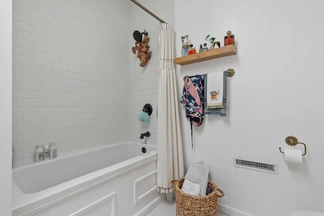 a bathroom with a bathtub and a shower