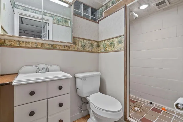 a bathroom with a sink a toilet and a mirror