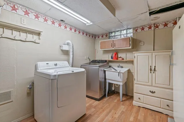 a utility room with cabinets dryer and washer