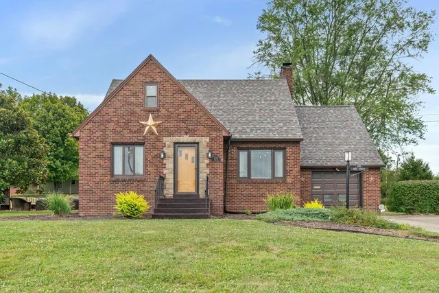 a front view of a house with a garden and plants