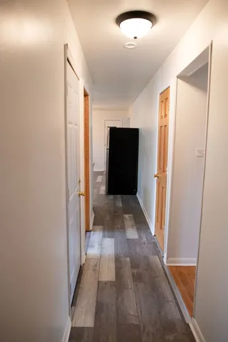 a view of hallway with wooden floor