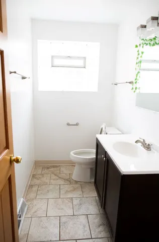 a bathroom with a sink a toilet and a mirror