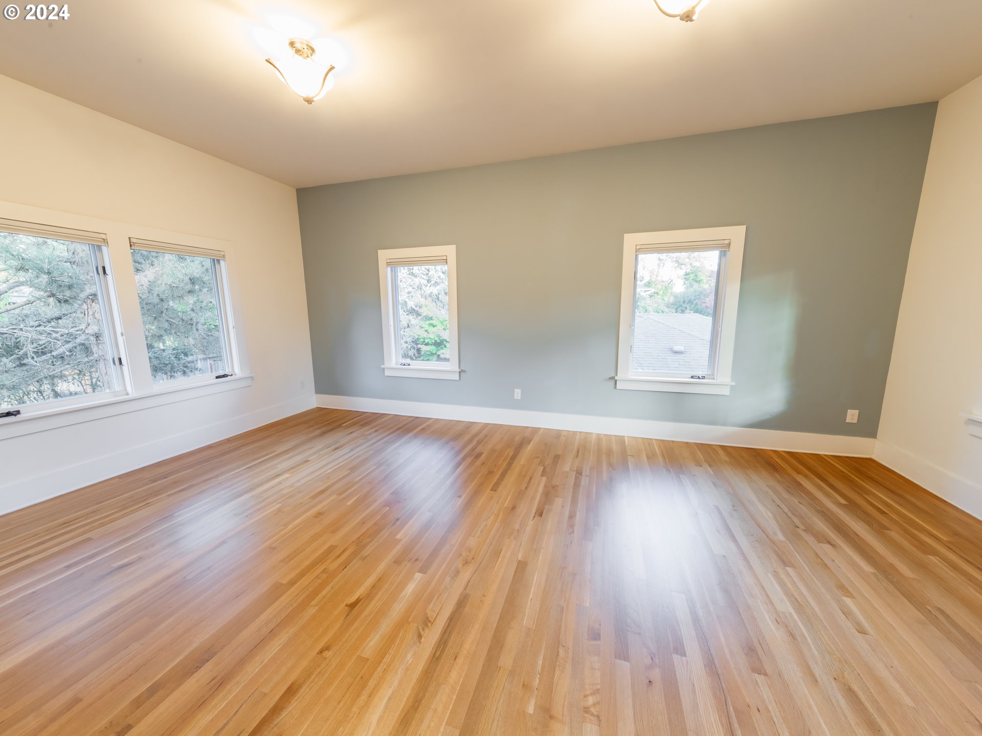 3117 Southeast Brooklyn Street Portland, OR 97202 - Photo 18 of 39 a view of empty room with wooden floor and fan