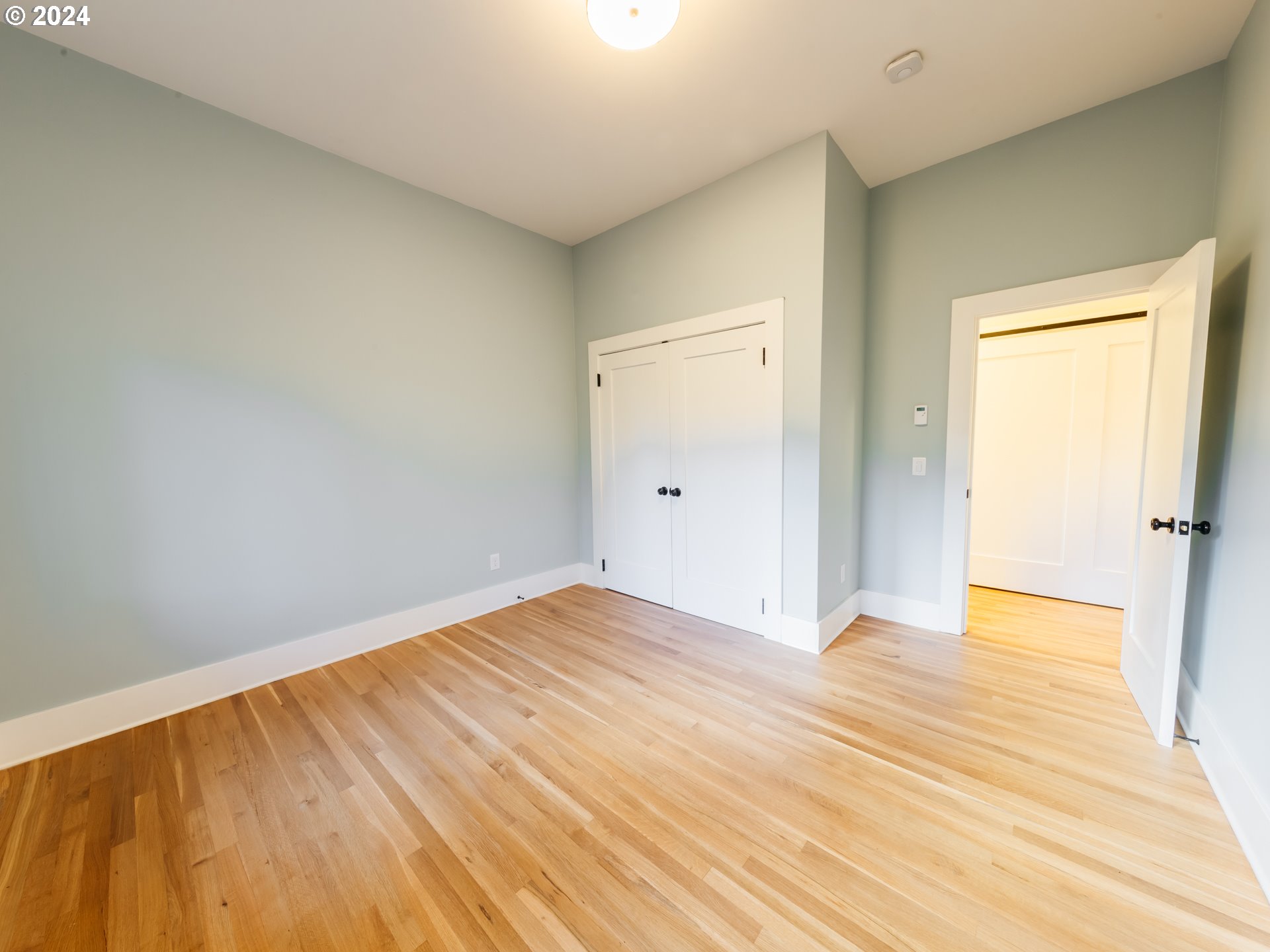 3117 Southeast Brooklyn Street Portland, OR 97202 - Photo 22 of 39 a view of an empty room with wooden floor