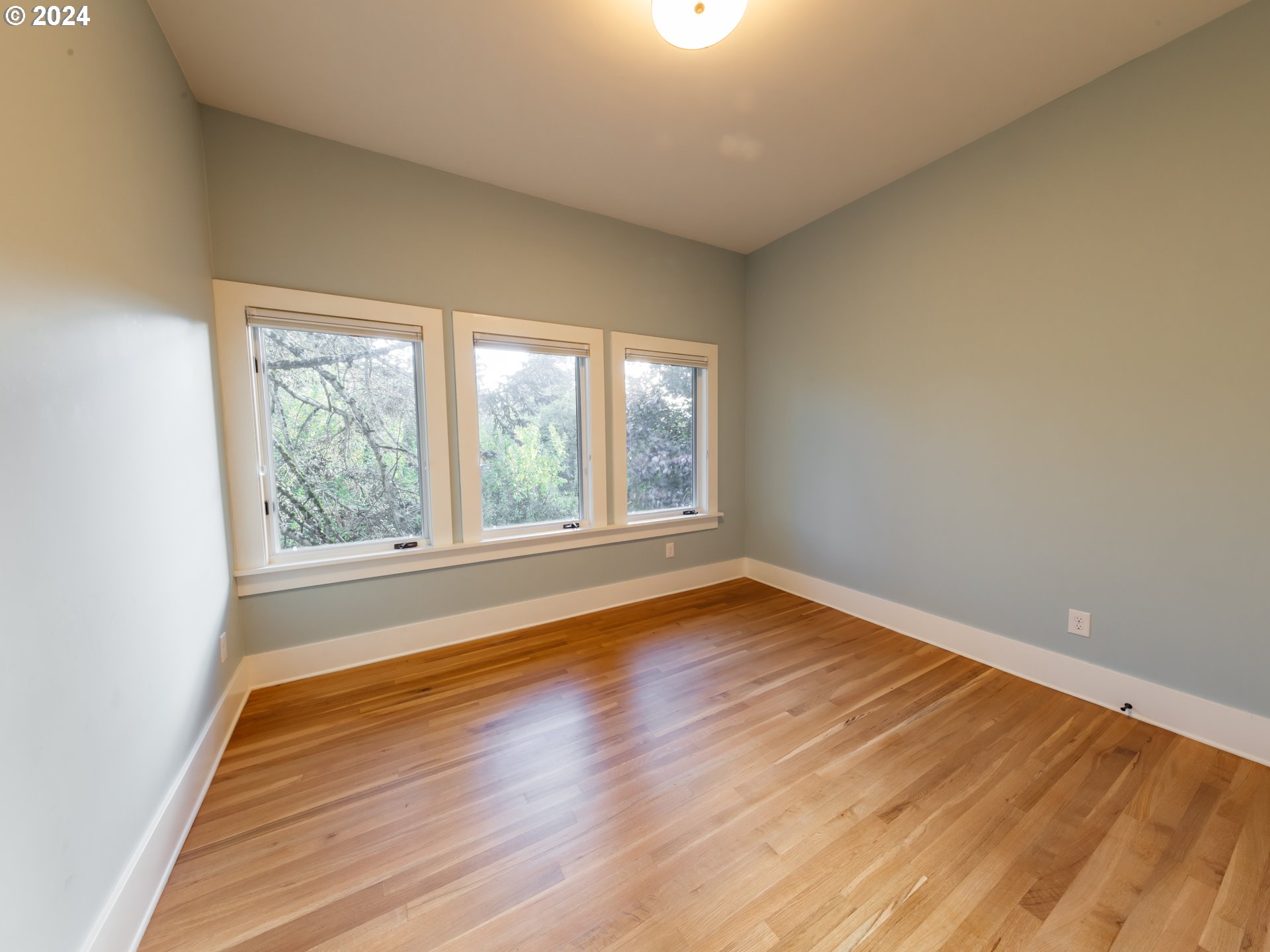 3117 Southeast Brooklyn Street Portland, OR 97202 - Photo 23 of 39 wooden floor in an empty room with a window