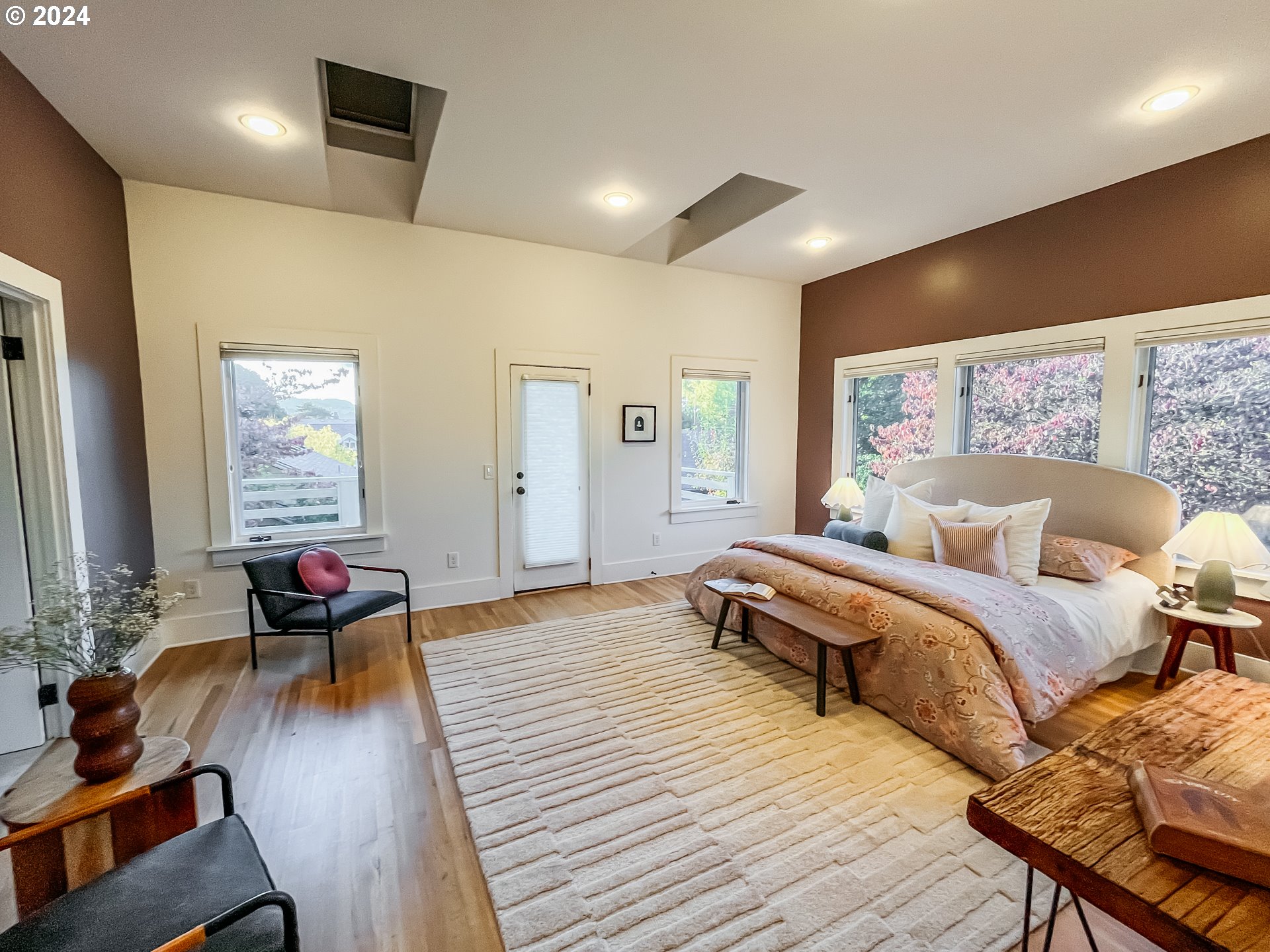 3117 Southeast Brooklyn Street Portland, OR 97202 - Photo 24 of 39 a spacious bedroom with a bed and wooden floor