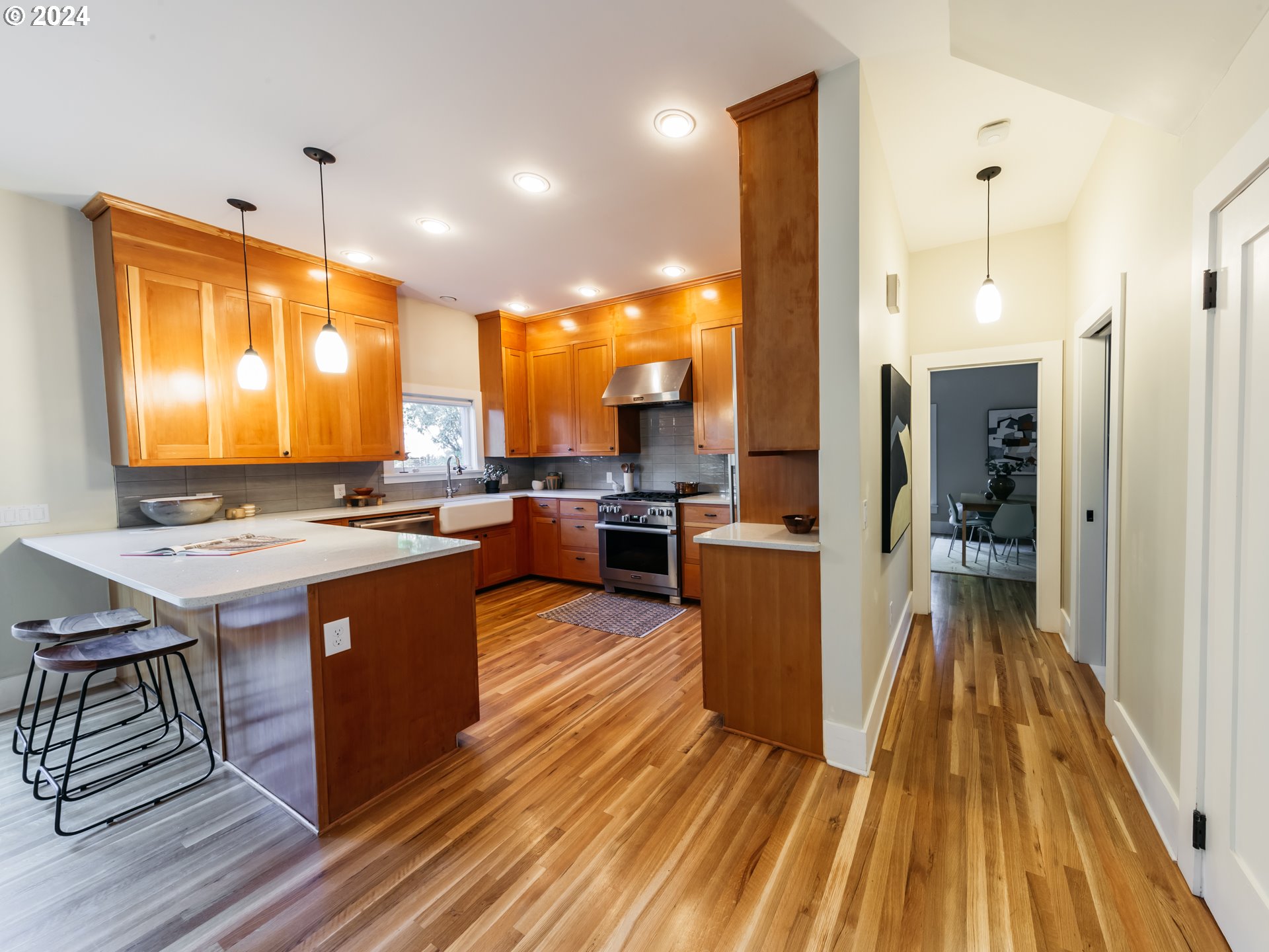 3117 Southeast Brooklyn Street Portland, OR 97202 - Photo 5 of 39 a kitchen with stainless steel appliances granite countertop wooden floors a sink and a stove