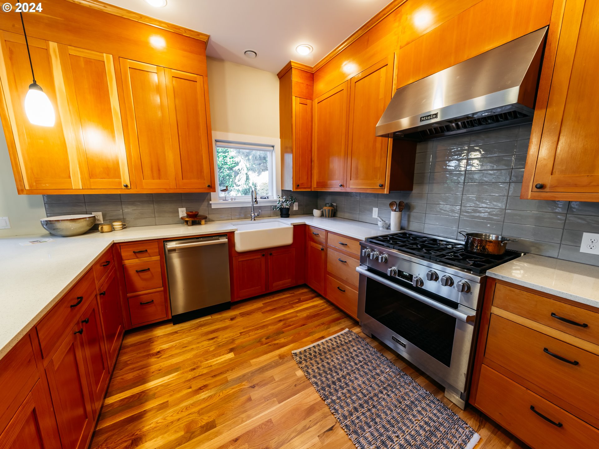 3117 Southeast Brooklyn Street Portland, OR 97202 - Photo 6 of 39 a kitchen with stainless steel appliances granite countertop a stove a sink dishwasher and cabinets