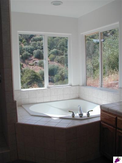 32276 Sycamore Road Tollhouse, CA 93667 - Photo 4 of 12 A lovely view from the Master bath facing a seasonal waterfall. A huge double headed tiled shower is seperate from the tub.