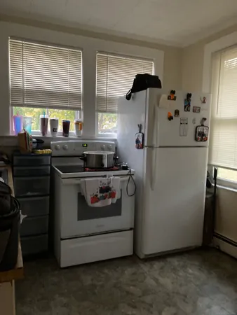 a kitchen with stainless steel appliances granite countertop a stove a refrigerator and a microwave