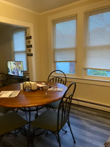 a view of a dining room with furniture and wooden floor