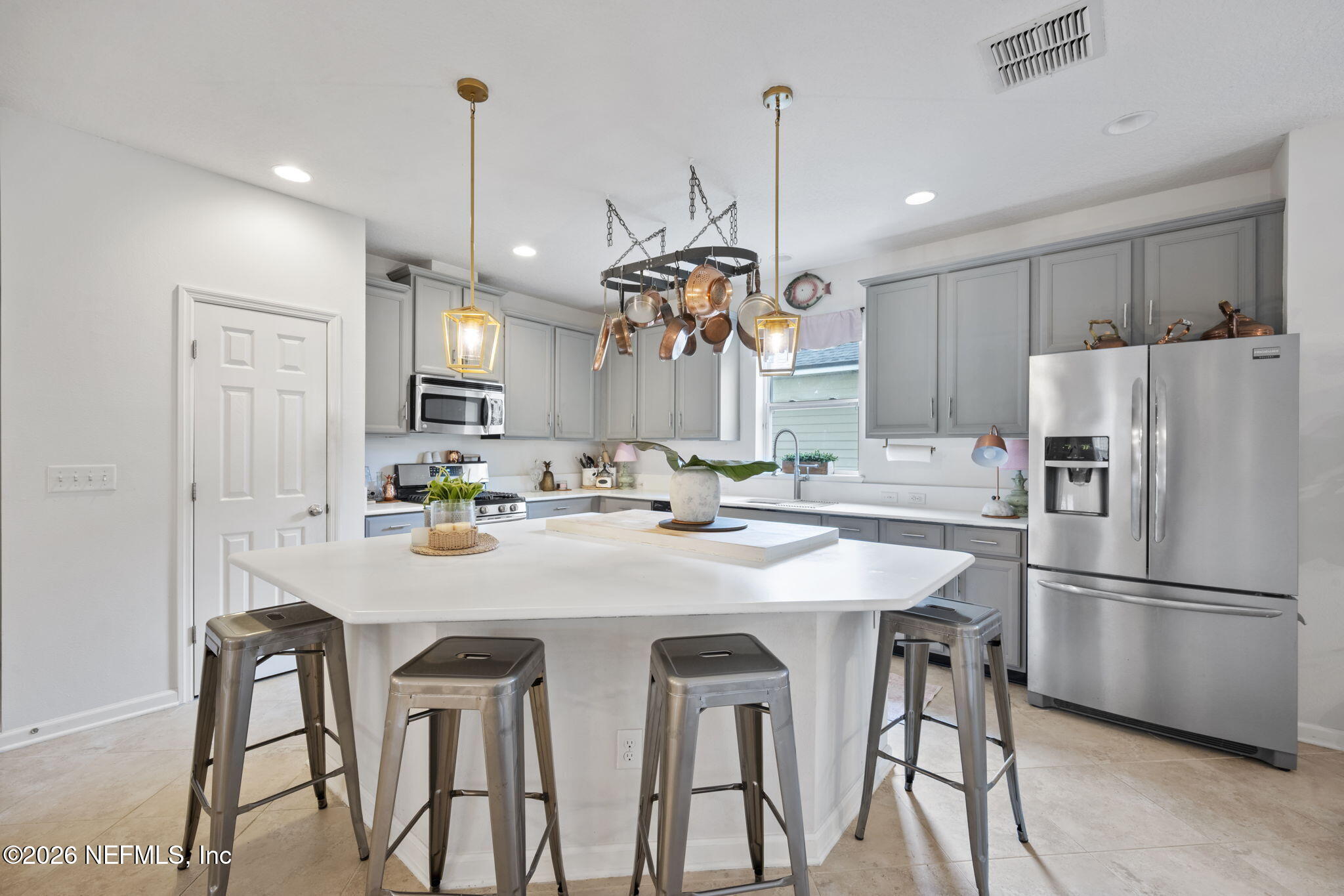 26 Olivette Street St. Johns, FL 32259 - Photo 8 of 42 a kitchen with stainless steel appliances a dining table chairs refrigerator and microwave