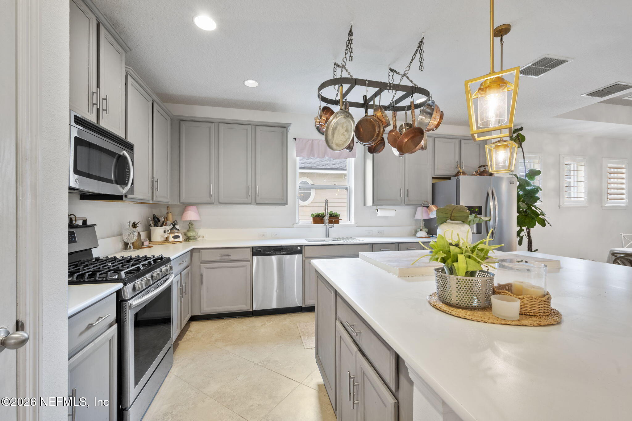26 Olivette Street St. Johns, FL 32259 - Photo 9 of 42 a kitchen with stainless steel appliances granite countertop a sink a stove top oven a counter space and cabinets