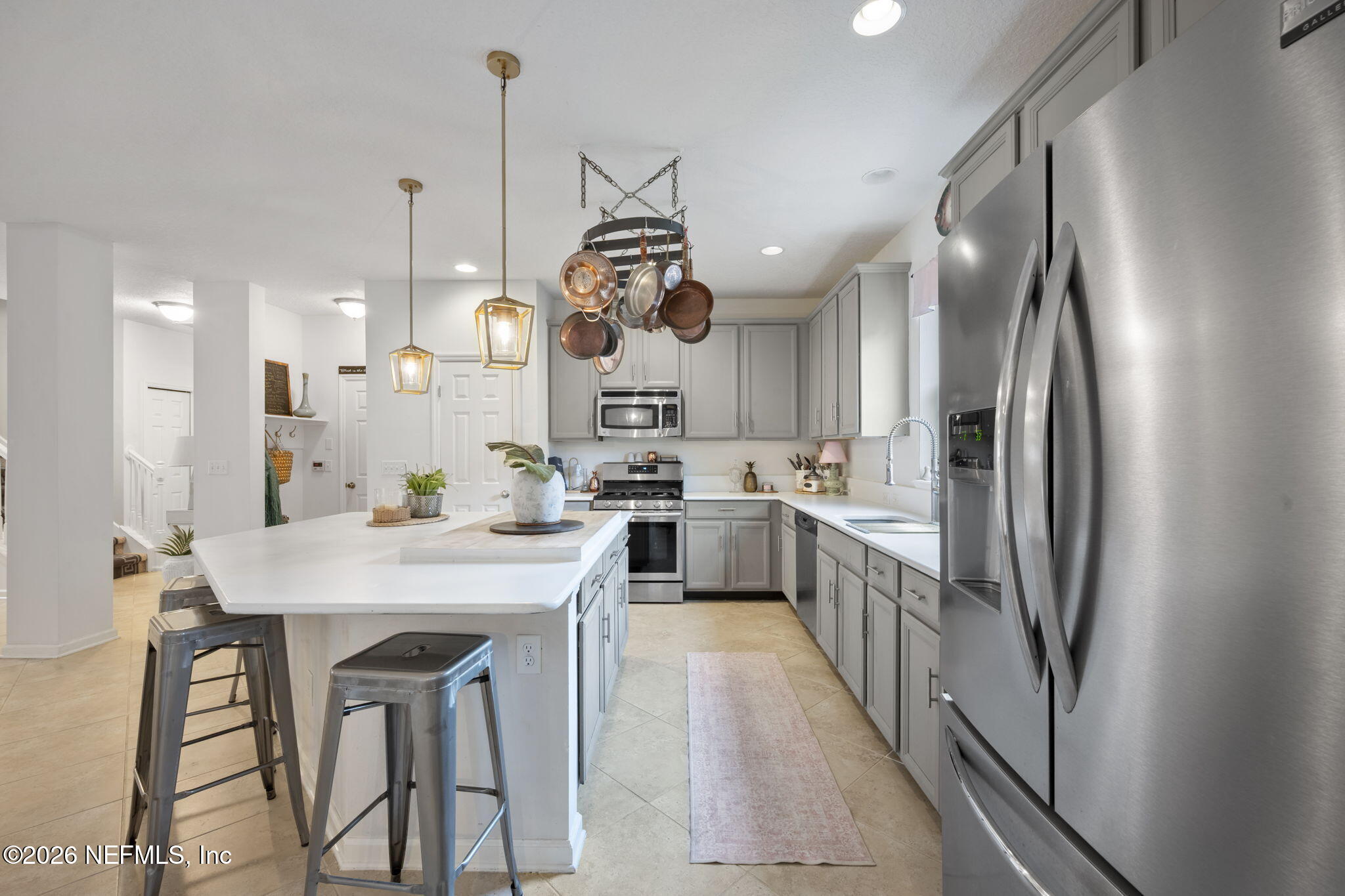 26 Olivette Street St. Johns, FL 32259 - Photo 10 of 42 a kitchen with stainless steel appliances kitchen island a table chairs sink and cabinets