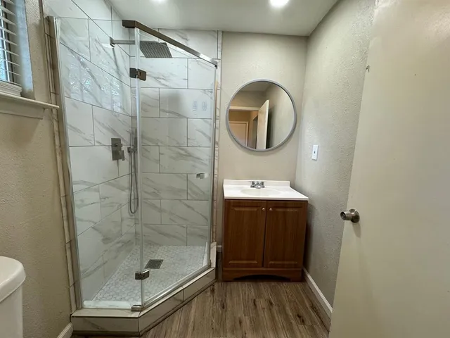a bathroom with a sink a mirror and a shower