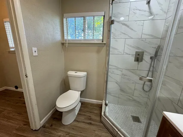 a bathroom with a toilet and a shower