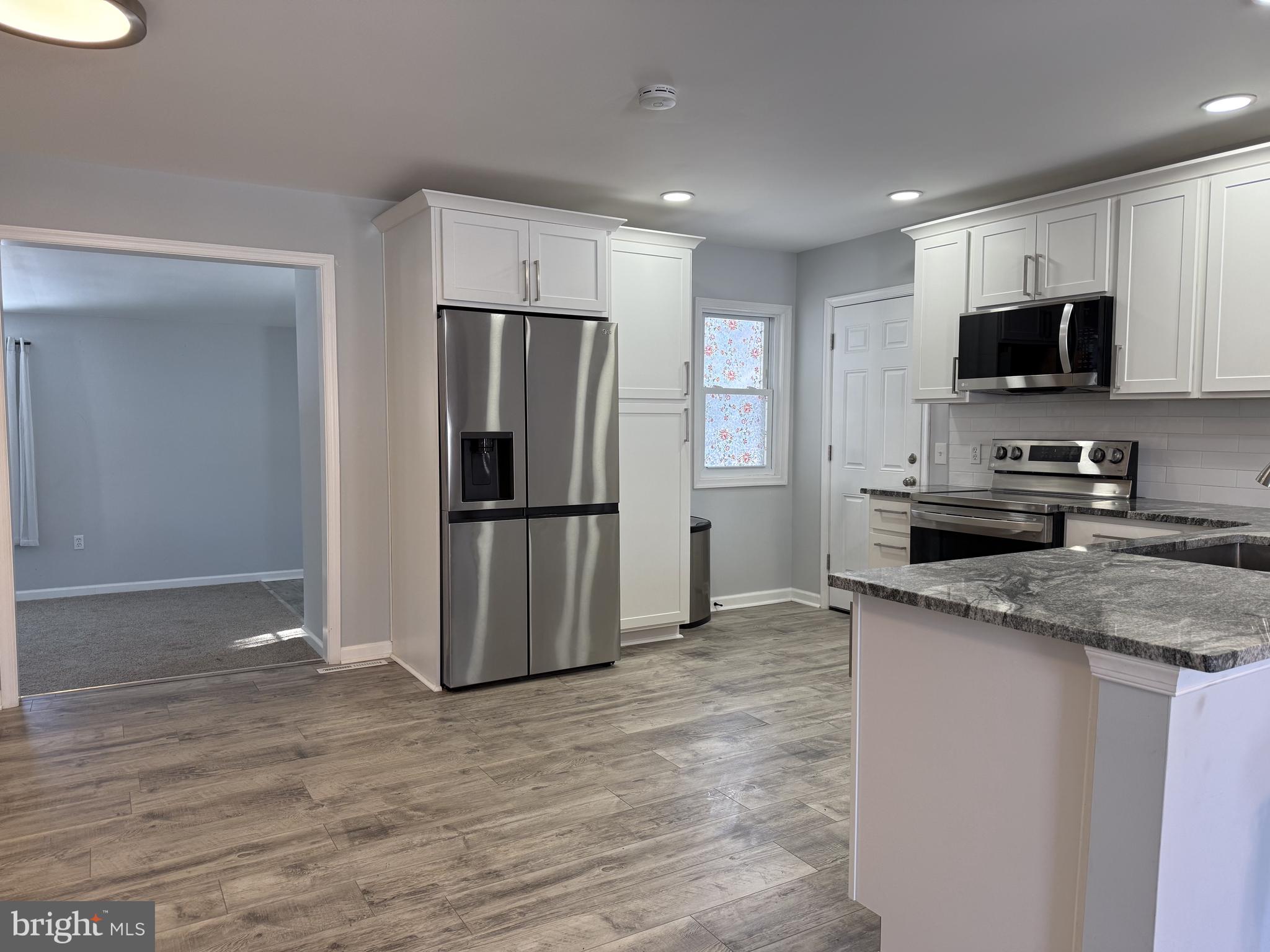 107 Anderson Road Newark, DE 19713 - Photo 2 of 11 a kitchen with stainless steel appliances granite countertop a refrigerator and a sink