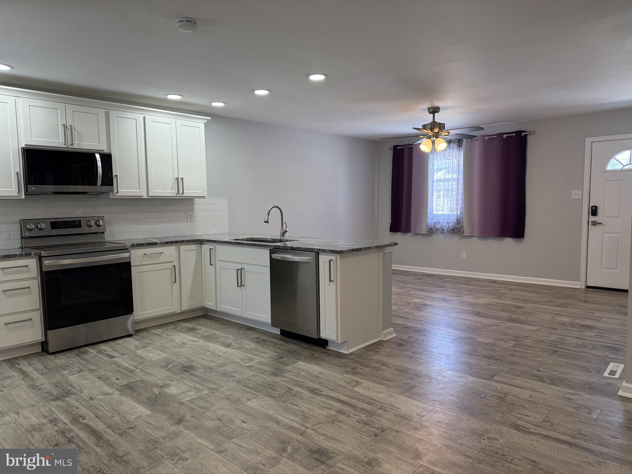 107 Anderson Road Newark, DE 19713 - Photo 3 of 11 a kitchen with stainless steel appliances granite countertop a sink a stove top oven a counter space and cabinets