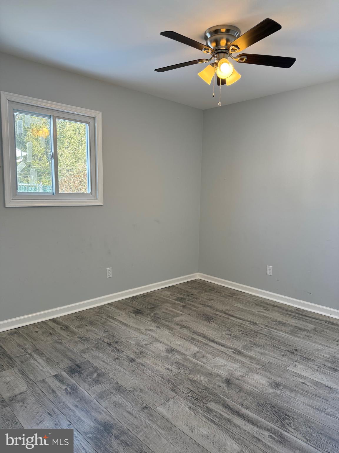 107 Anderson Road Newark, DE 19713 - Photo 6 of 11 a view of an empty room with a window and a chandelier fan