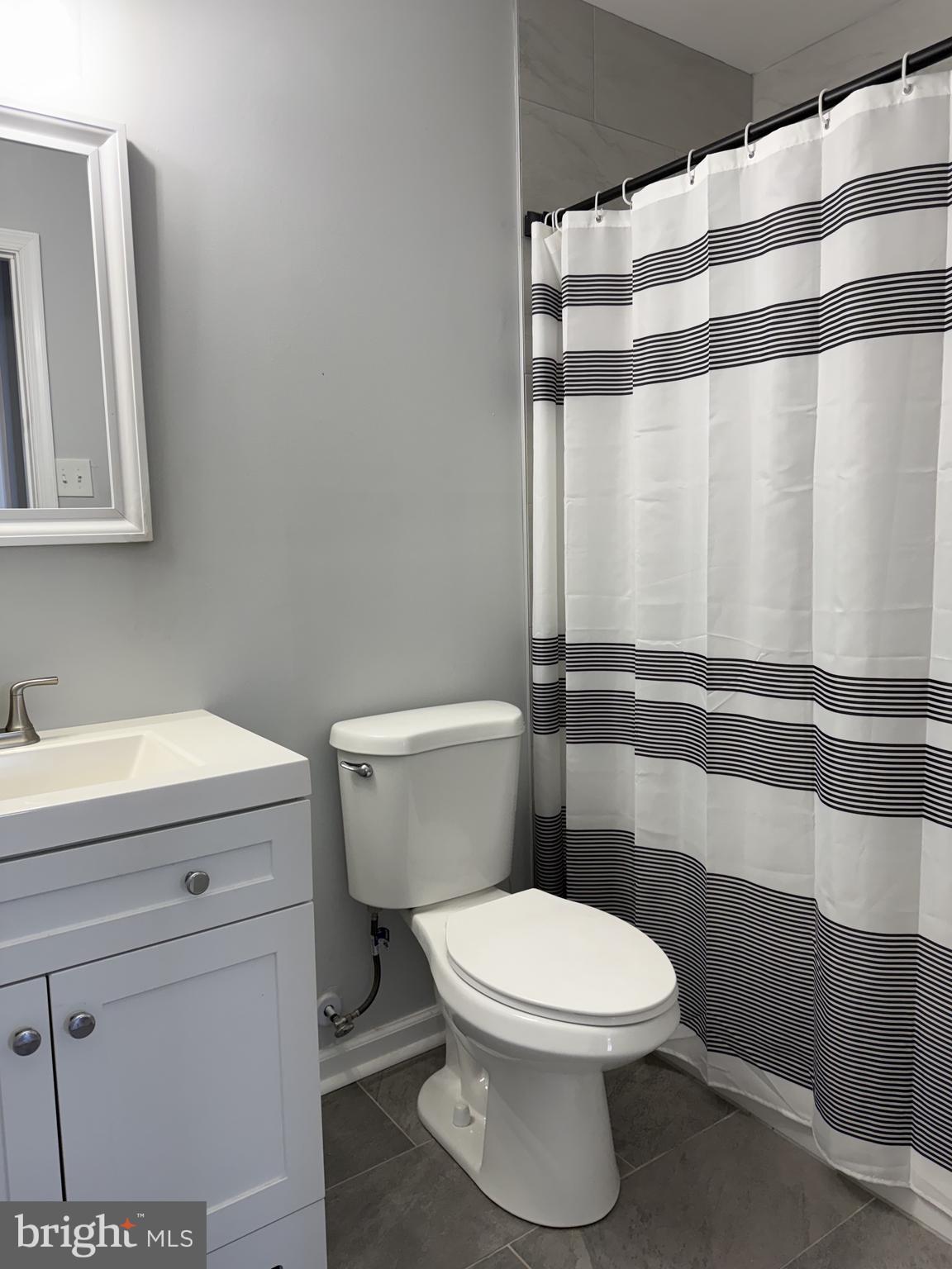 107 Anderson Road Newark, DE 19713 - Photo 10 of 11 a bathroom with a toilet and a shower curtain