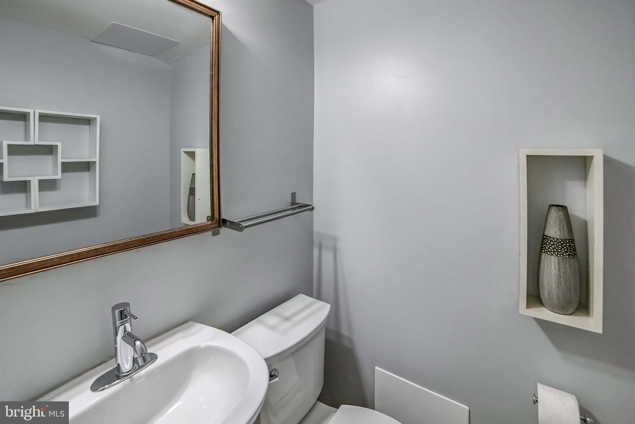 9551 Saddlebag Row Columbia, MD 21045 - Photo 11 of 30 a bathroom with a toilet sink and mirror