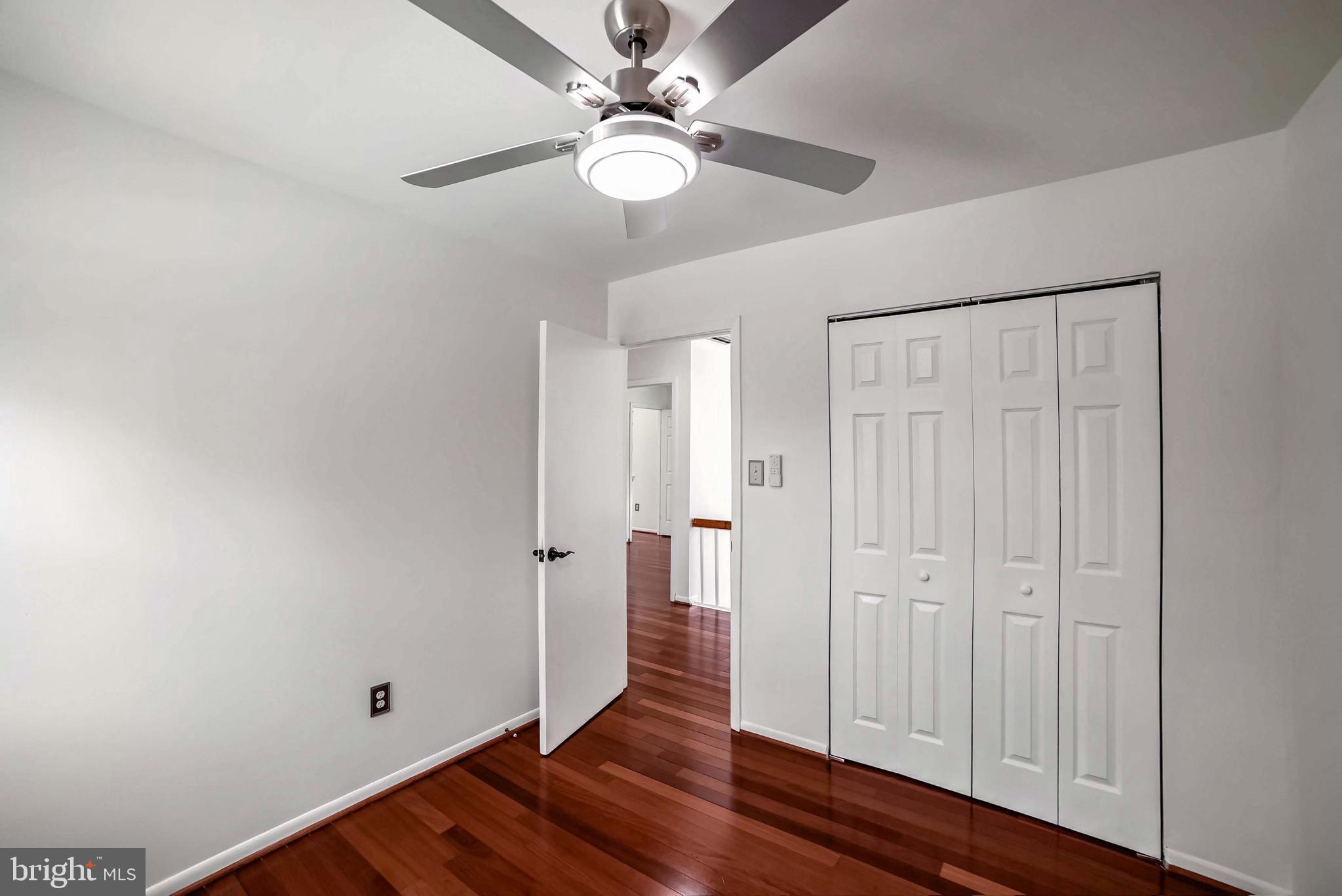9551 Saddlebag Row Columbia, MD 21045 - Photo 13 of 30 a view of an empty room with wooden floor
