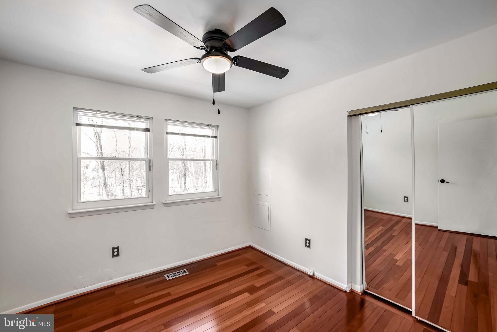 9551 Saddlebag Row Columbia, MD 21045 - Photo 14 of 30 a view of empty room with wooden floor and fan