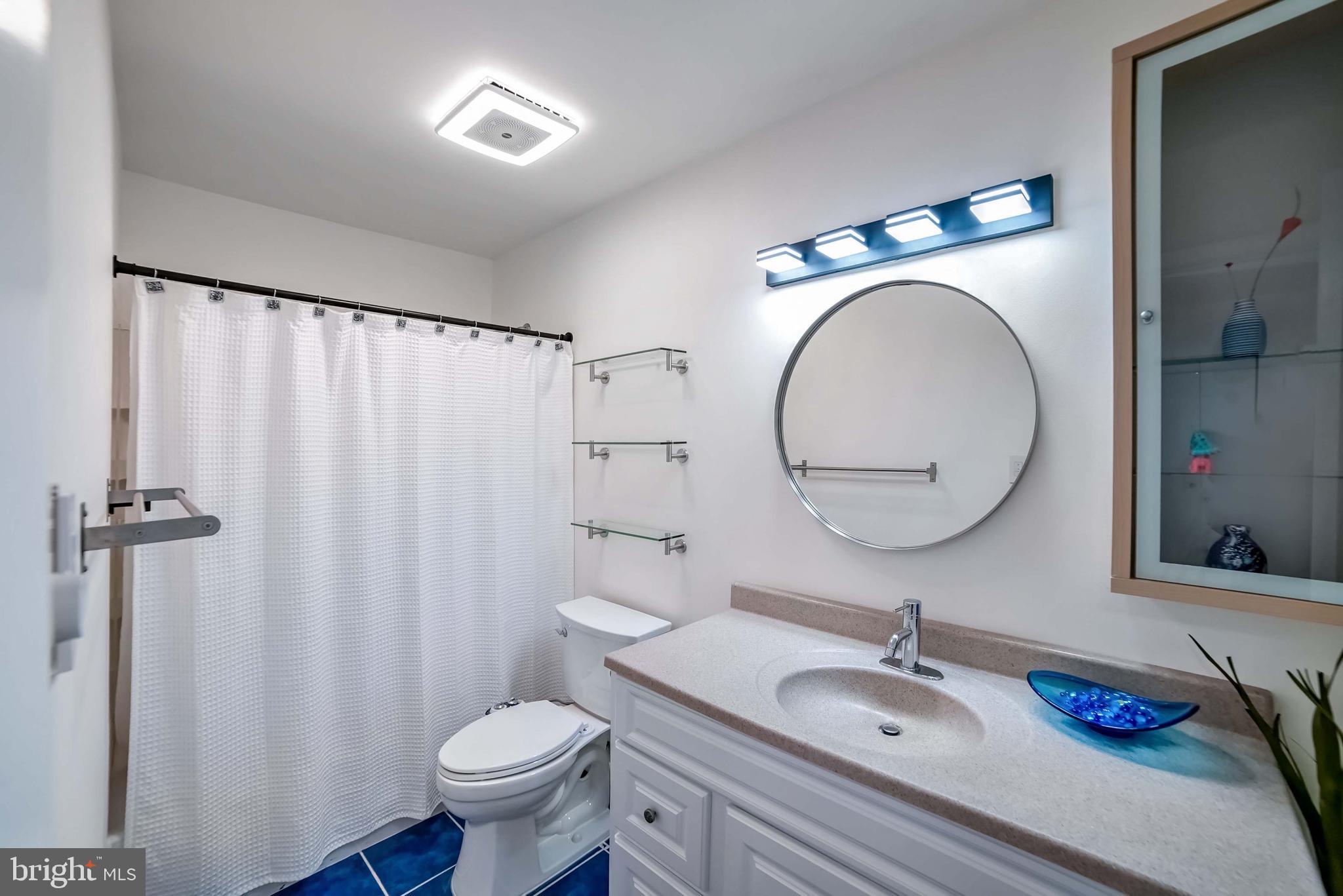 9551 Saddlebag Row Columbia, MD 21045 - Photo 16 of 30 a bathroom with a granite countertop sink toilet and a mirror