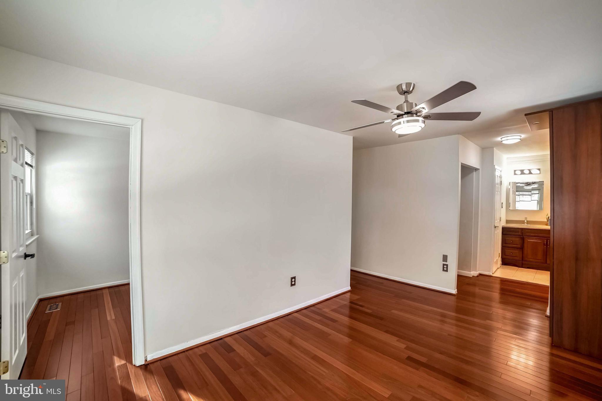 9551 Saddlebag Row Columbia, MD 21045 - Photo 18 of 30 a view of an empty room with wooden floor
