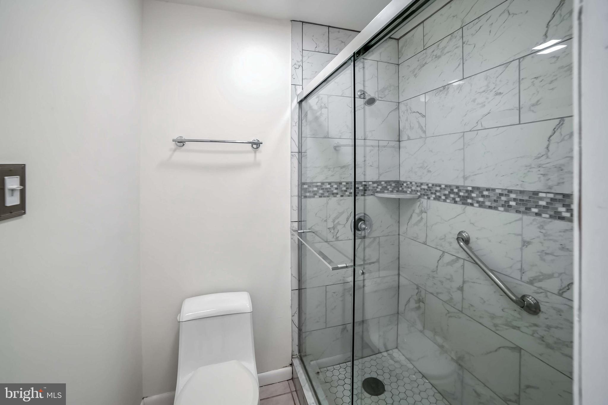 9551 Saddlebag Row Columbia, MD 21045 - Photo 20 of 30 a bathroom with a shower and toilet