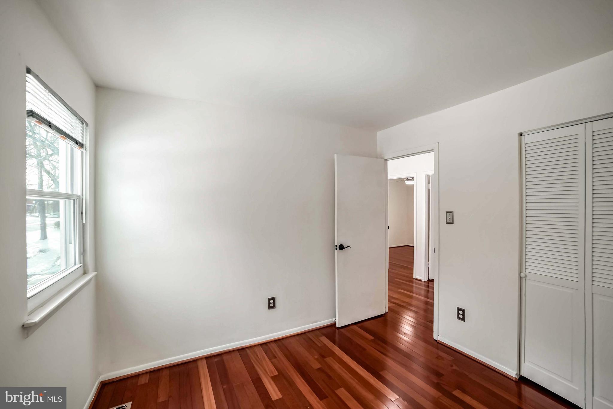 9551 Saddlebag Row Columbia, MD 21045 - Photo 21 of 30 an empty room with wooden floor and windows