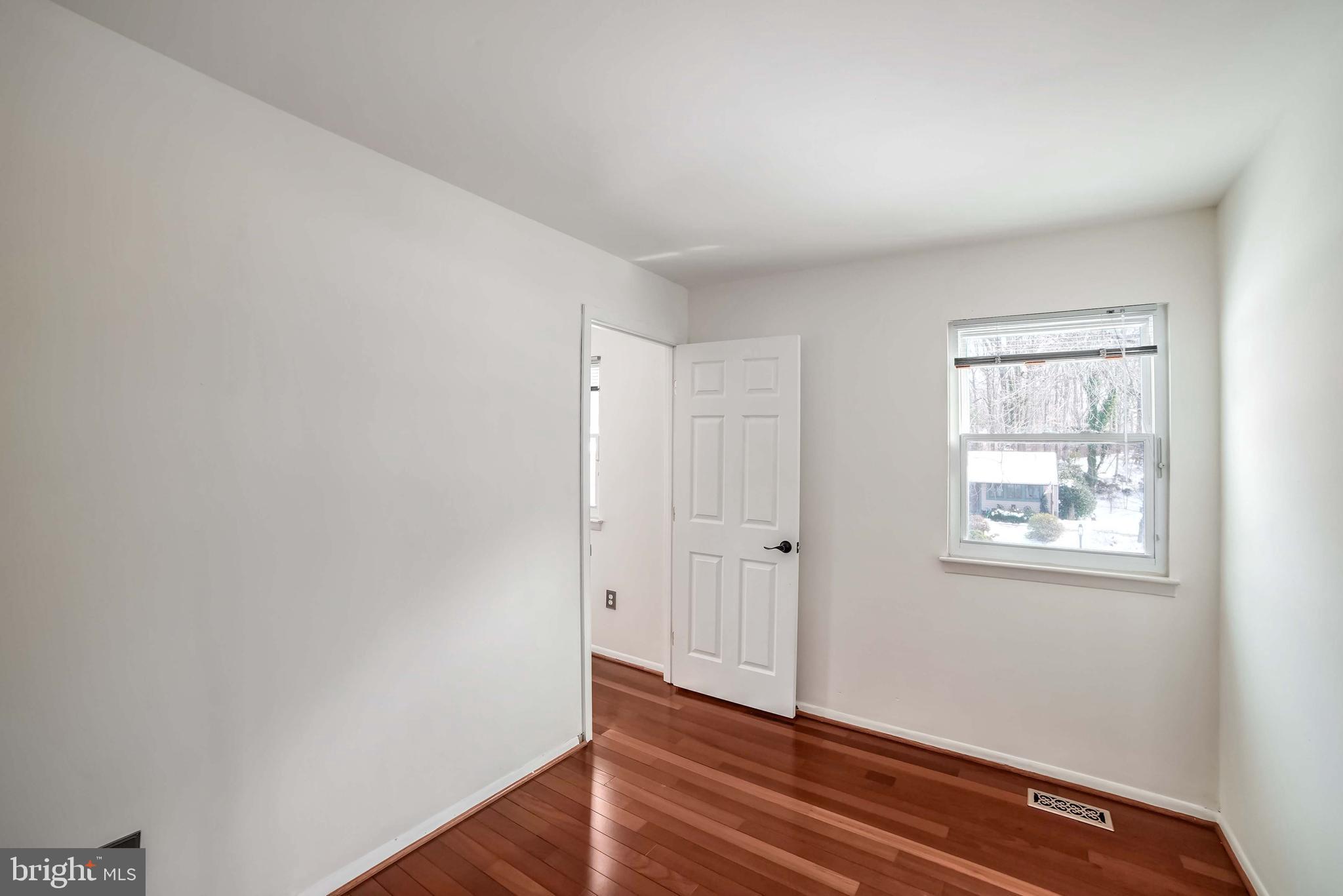 9551 Saddlebag Row Columbia, MD 21045 - Photo 22 of 30 an empty room with wooden floor and windows