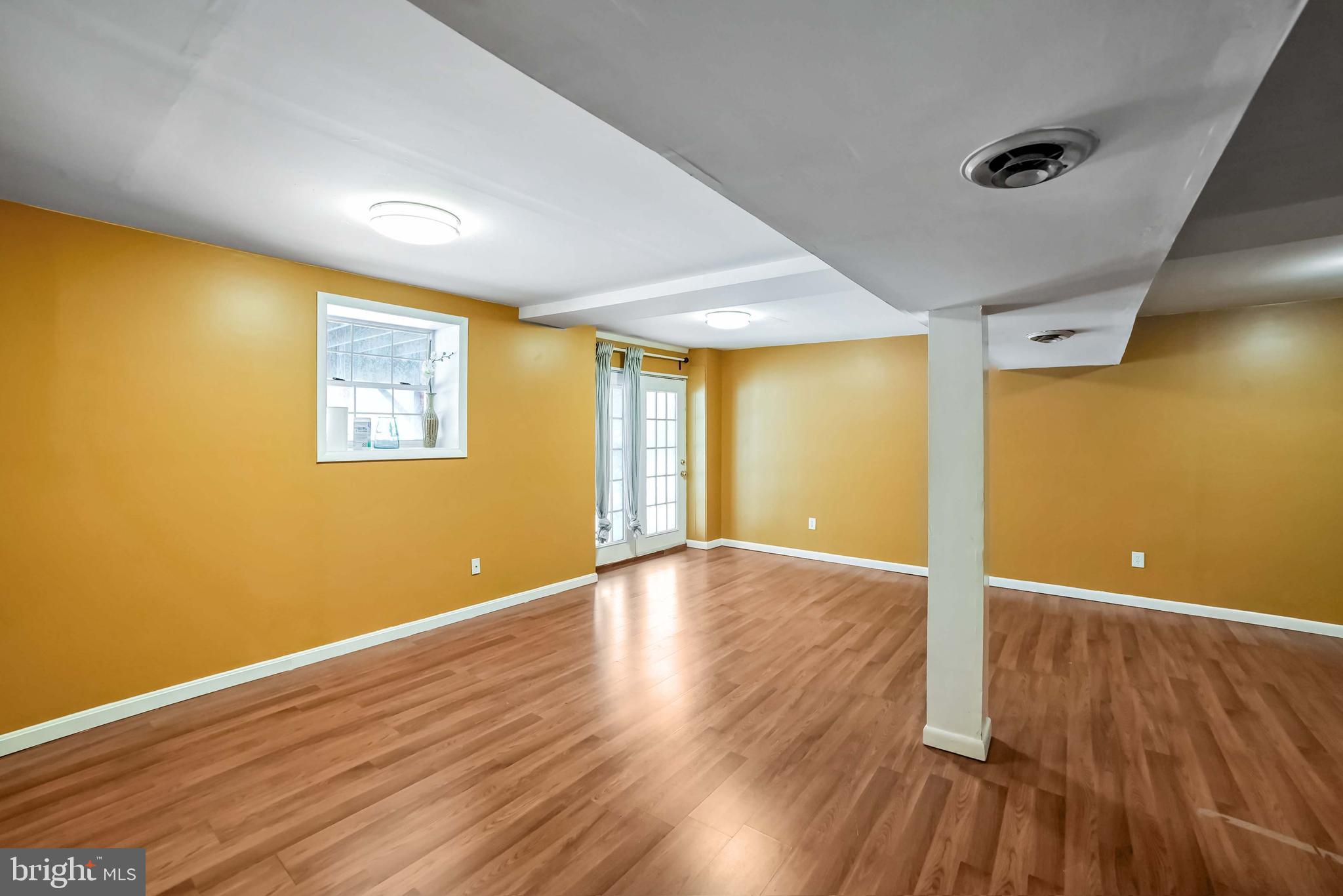 9551 Saddlebag Row Columbia, MD 21045 - Photo 23 of 30 a view of an empty room with wooden floor and a window
