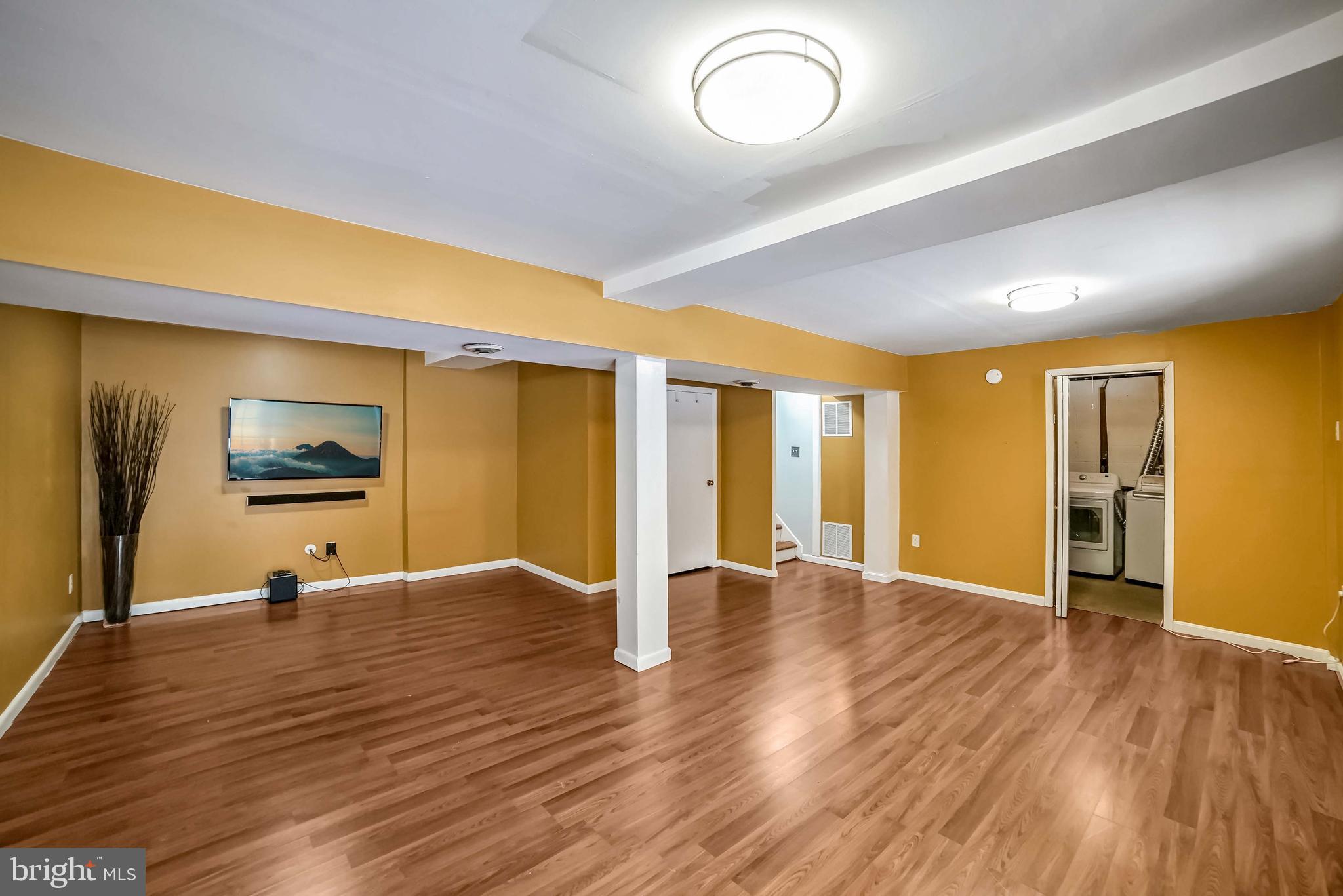 9551 Saddlebag Row Columbia, MD 21045 - Photo 24 of 30 a view of an empty room with window and wooden floor