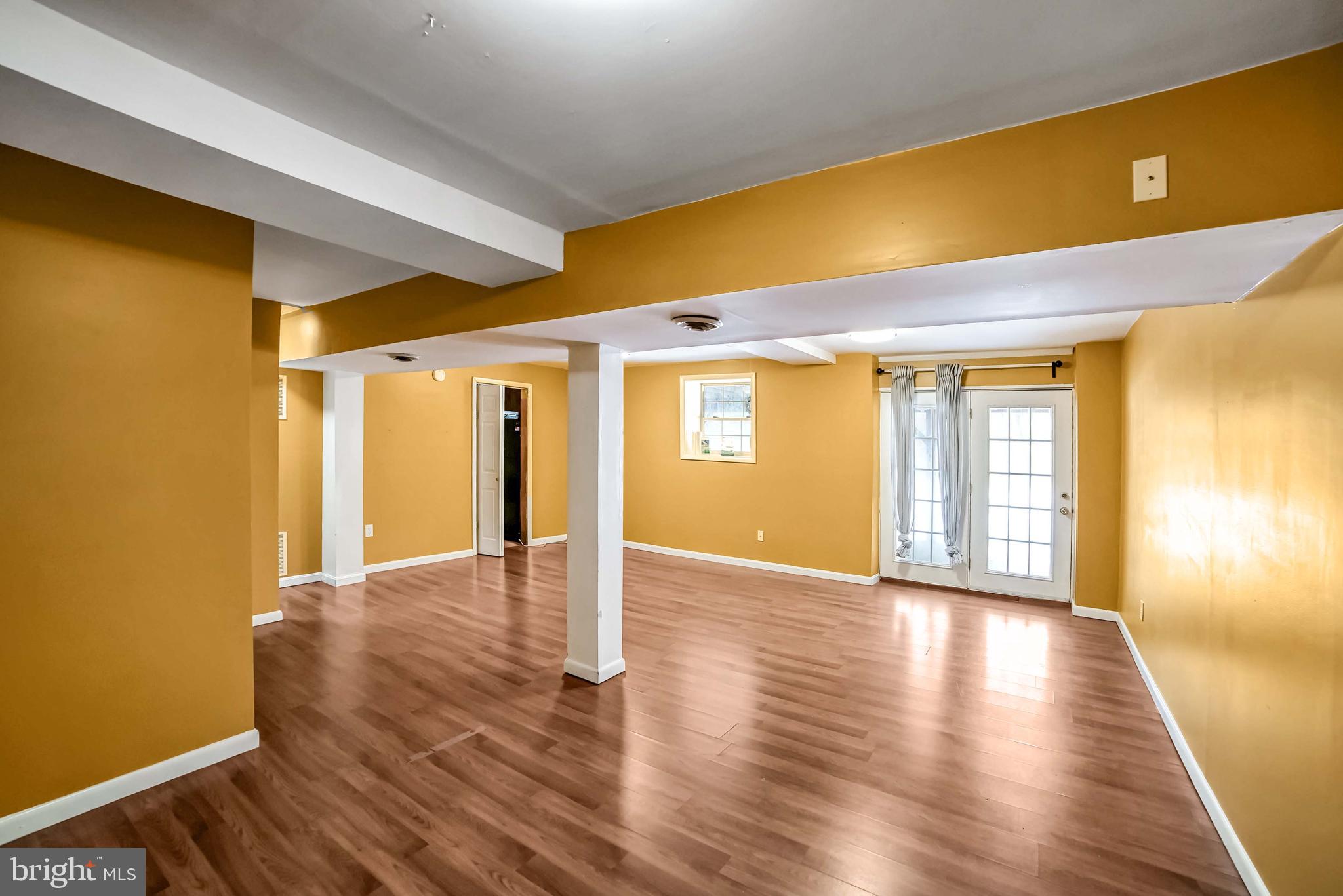 9551 Saddlebag Row Columbia, MD 21045 - Photo 25 of 30 a view of an empty room with wooden floor and a window
