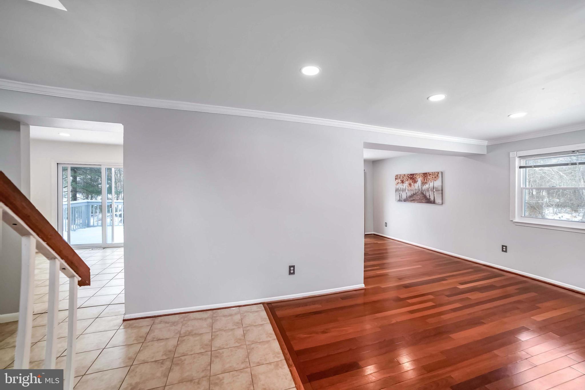 9551 Saddlebag Row Columbia, MD 21045 - Photo 3 of 30 a view of an empty room with wooden floor and a window