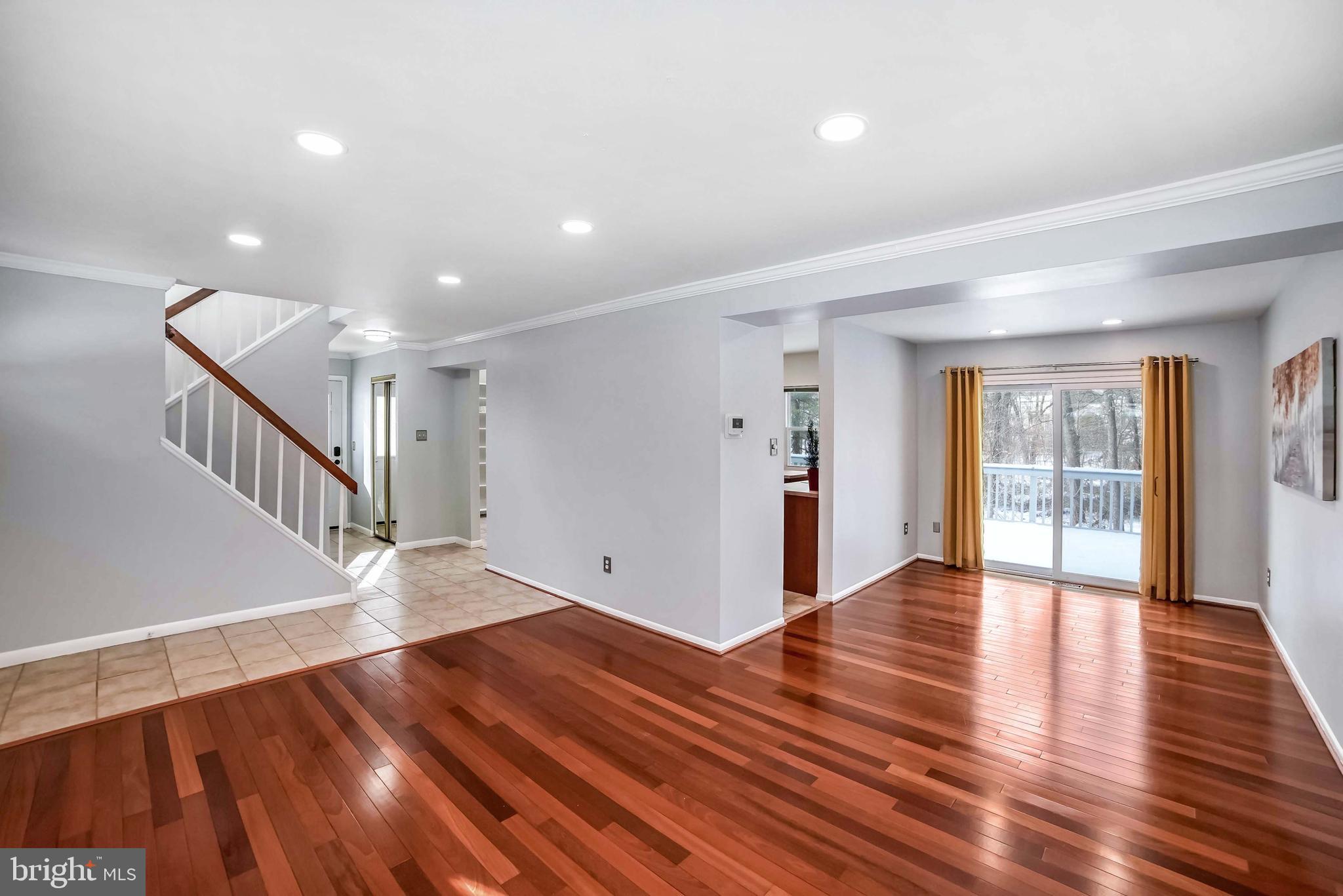 9551 Saddlebag Row Columbia, MD 21045 - Photo 4 of 30 a view of an empty room with wooden floor and a window