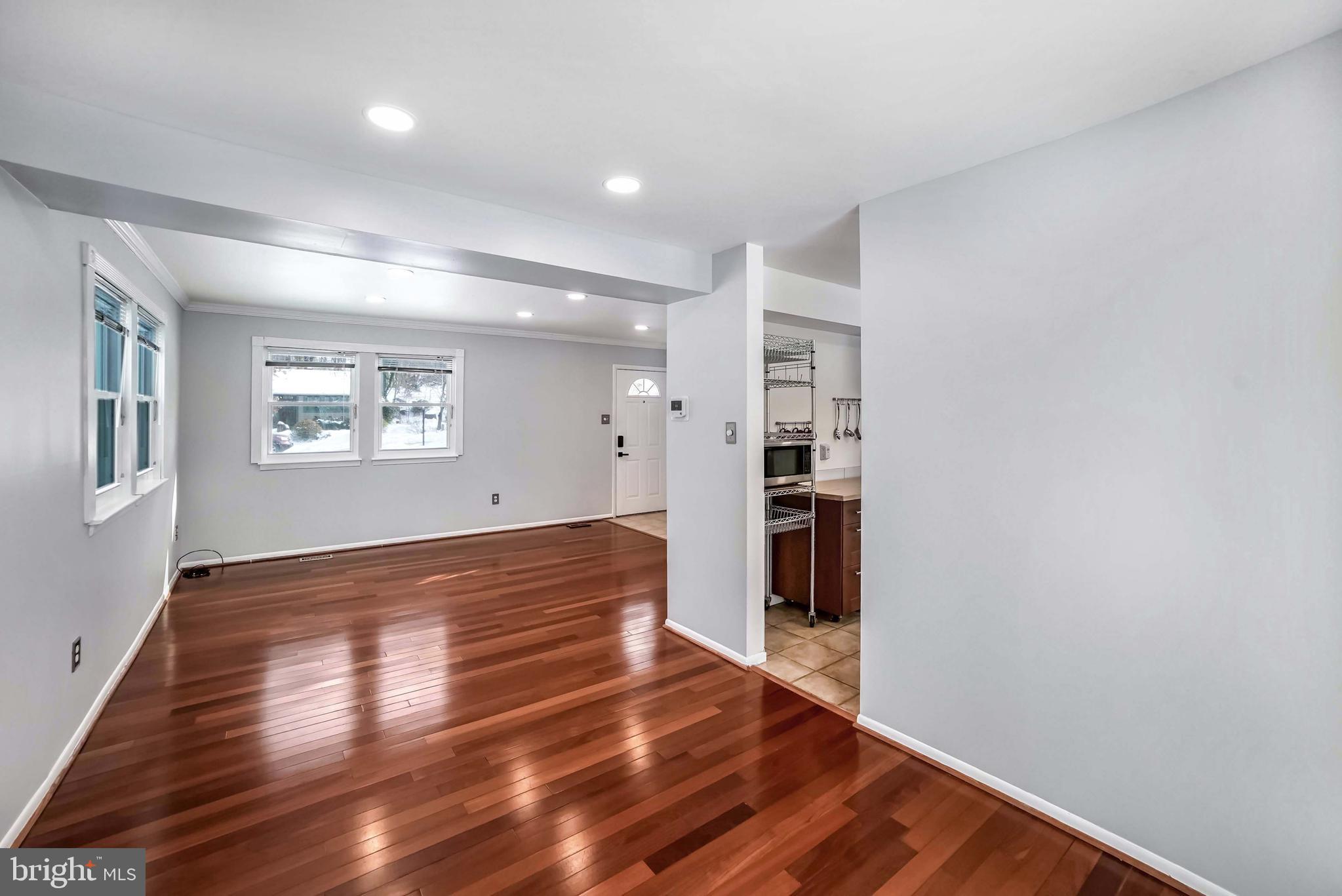 9551 Saddlebag Row Columbia, MD 21045 - Photo 5 of 30 a view of empty room with wooden floor and windows