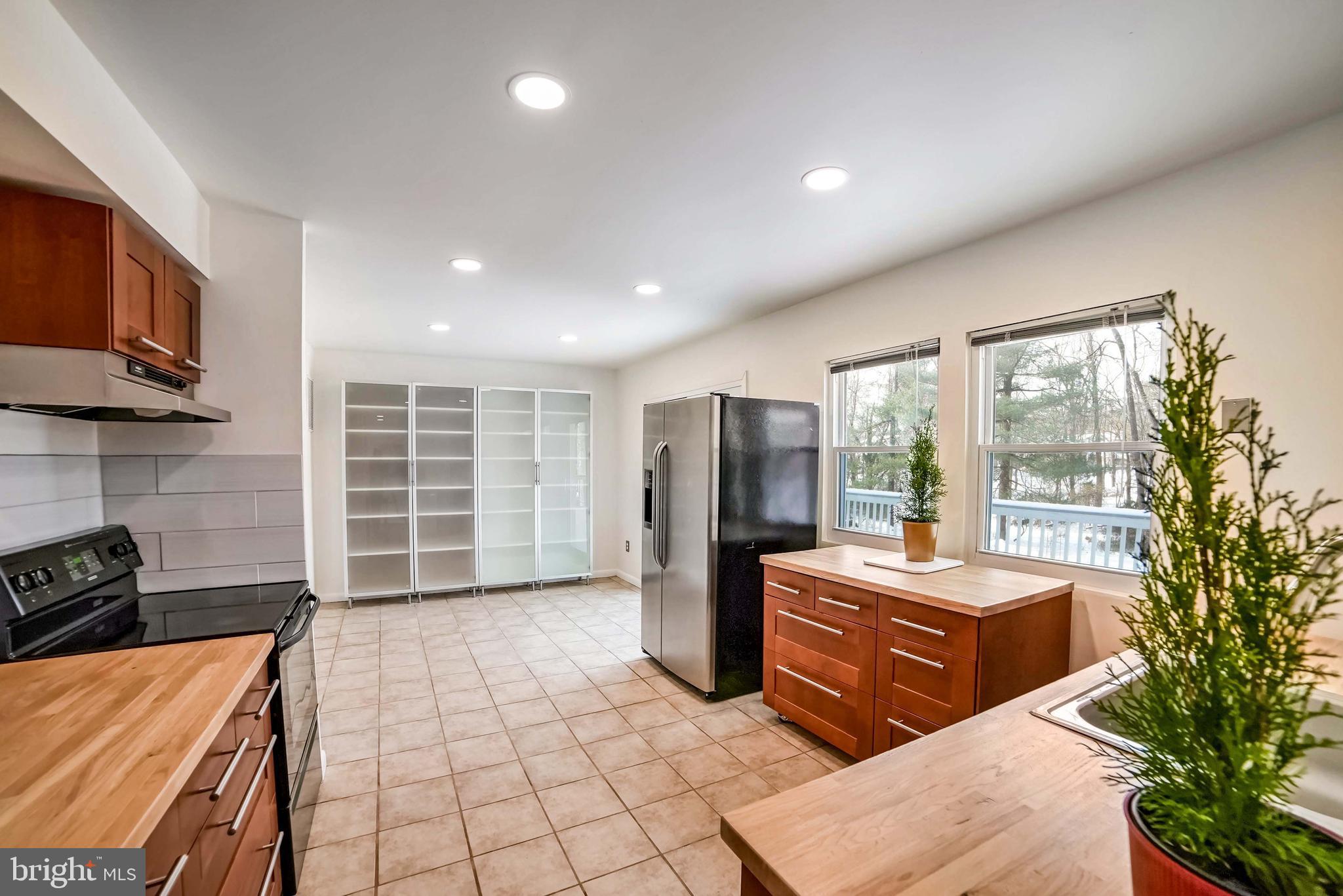 9551 Saddlebag Row Columbia, MD 21045 - Photo 7 of 30 a room with furniture a flat screen tv and a refrigerator