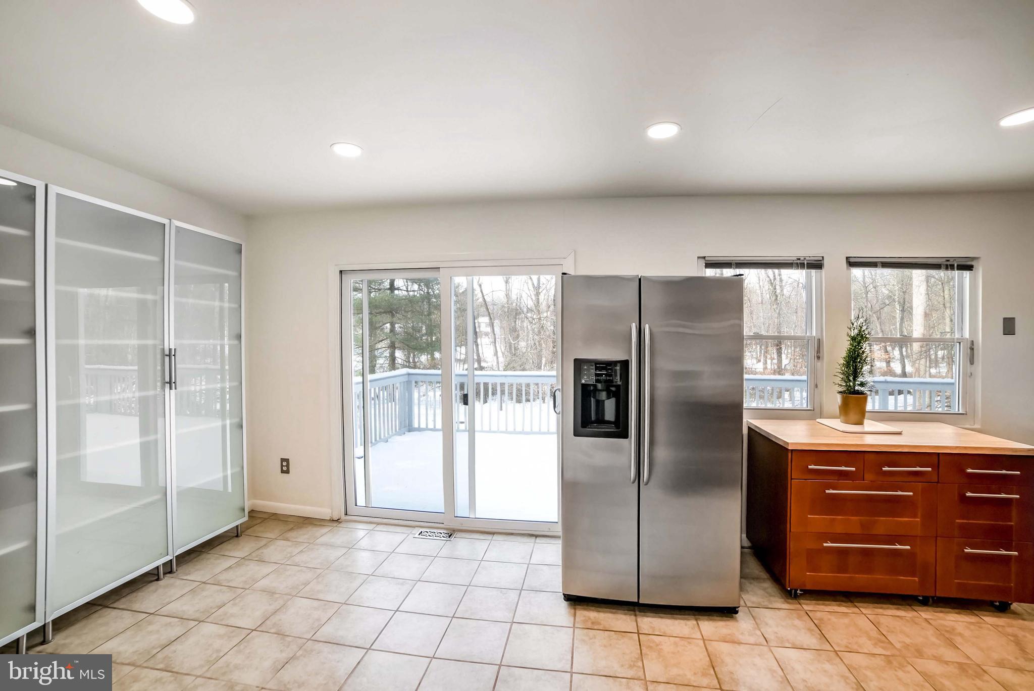 9551 Saddlebag Row Columbia, MD 21045 - Photo 8 of 30 a kitchen with a refrigerator a sink and cabinets