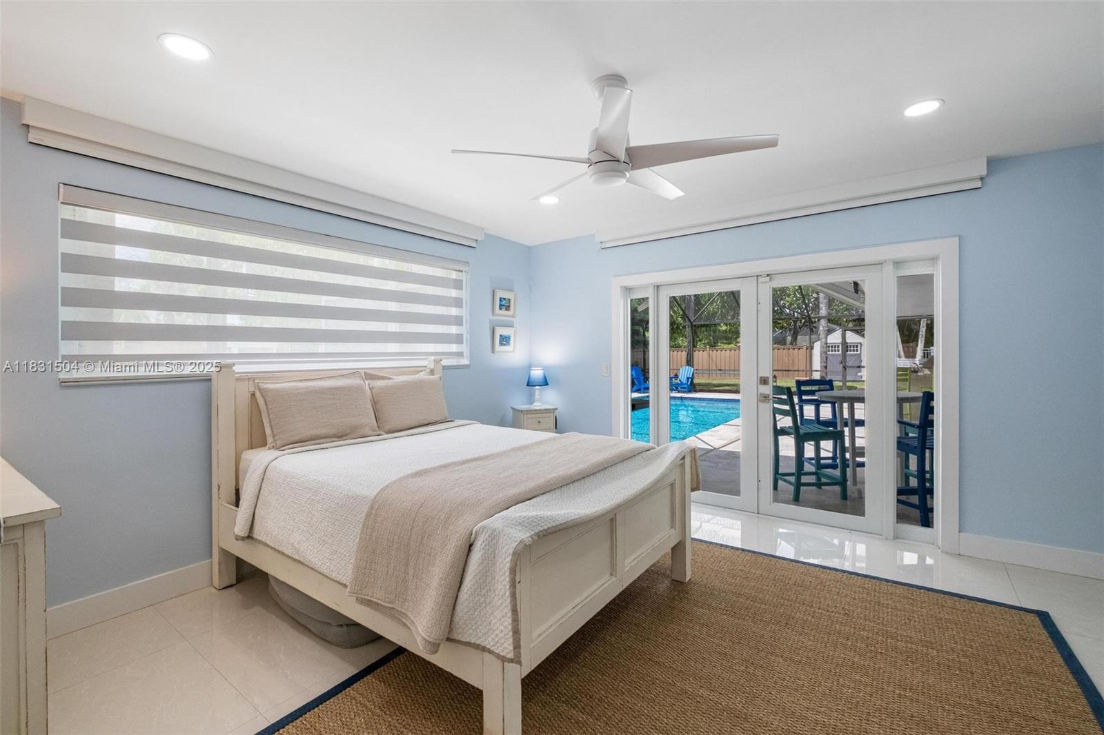 9720 Southwest 140th Street Miami, FL 33176 - Photo 11 of 24 a bedroom with a large bed and a chandelier
