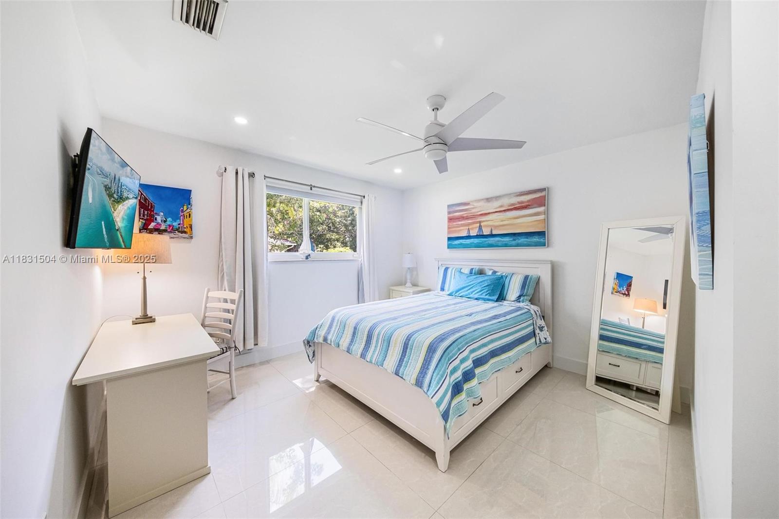 9720 Southwest 140th Street Miami, FL 33176 - Photo 14 of 24 a spacious bedroom with a bed and a chandelier