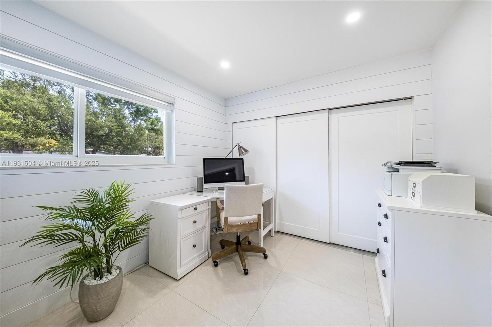 9720 Southwest 140th Street Miami, FL 33176 - Photo 16 of 24 a view of a workspace with furniture and a potted plant