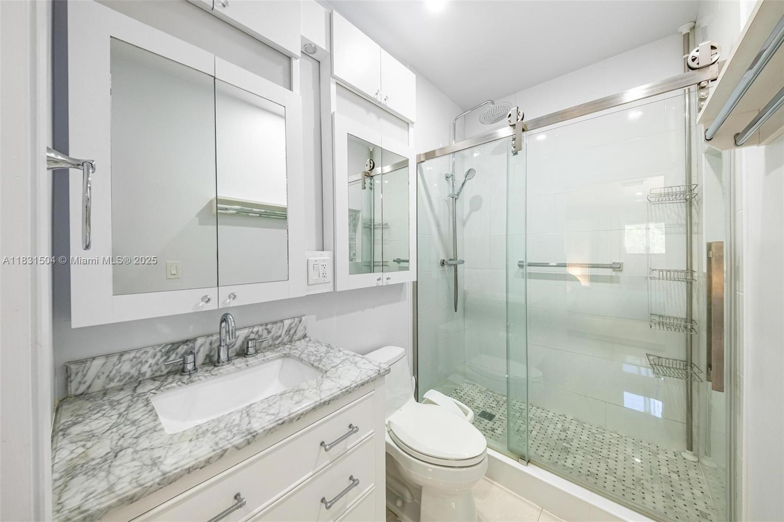 9720 Southwest 140th Street Miami, FL 33176 - Photo 20 of 24 a bathroom with a granite countertop sink toilet mirror and shower